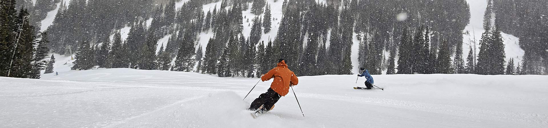 Two skiers at Breckenridge on powder day 1920x450