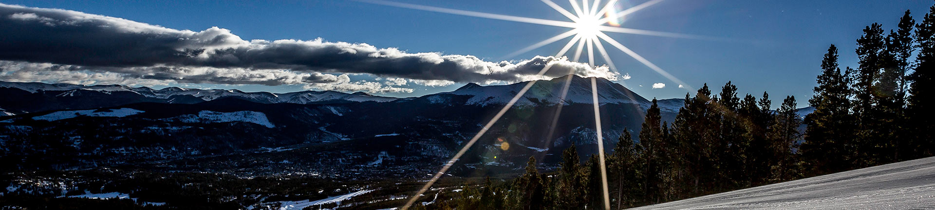 1920x450 sun setting over breckenridge snow